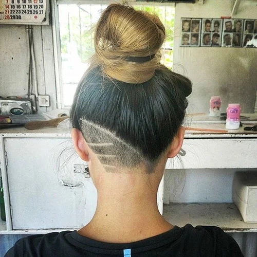 High bun with a teal nape undercut traced at the back