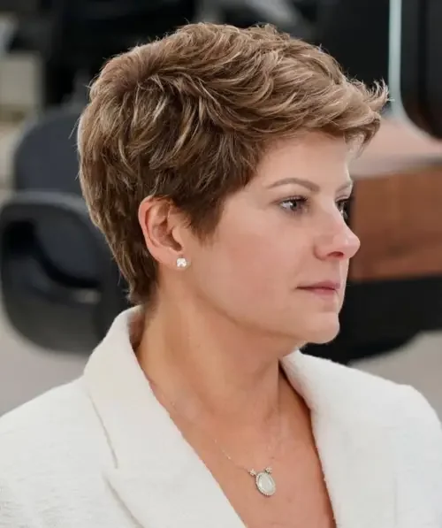 Short brunette pixie with textured crown and subtle lighter streaks