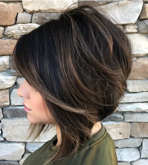Angled bob with elongated front pieces and warm brown balayage dimension.