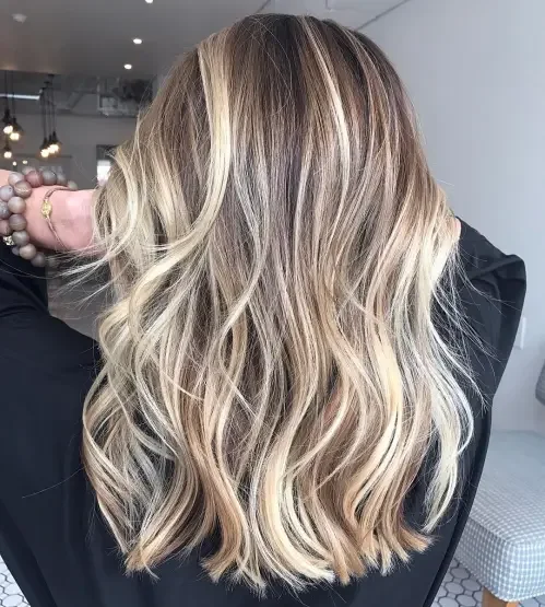 Long choppy layered hair with blonde balayage over brown