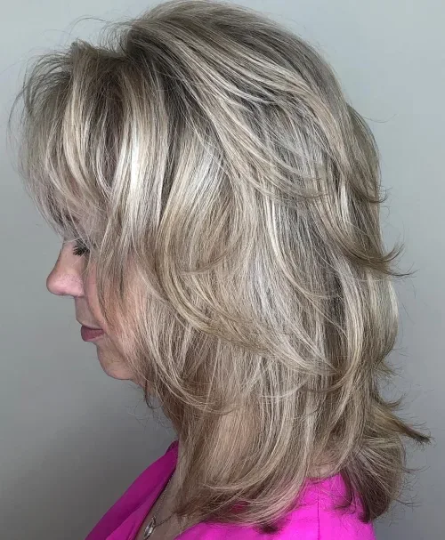 Piecey feathered medium shag with wispy fringe, smoky light blonde and cool highlights, airy texture