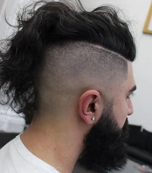 Long wavy top with a shaved undercut and high contrast dark color