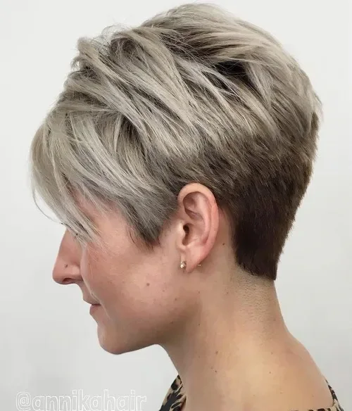 Ashy blonde side-swept pixie with tapered sides and textured top
