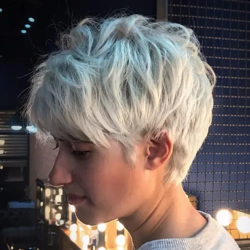 Tousled feathered pixie with wispy fringe and light ash blonde color