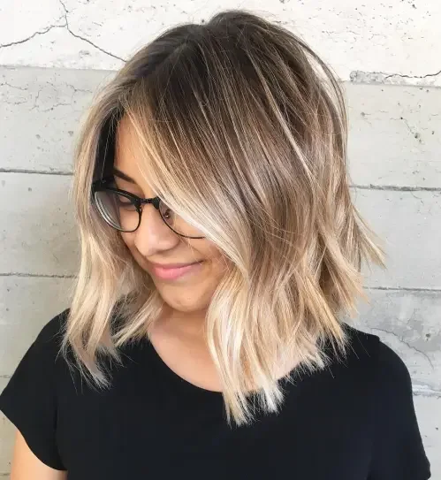 Shoulder-length choppy lob with blonde balayage highlights and piecey layers