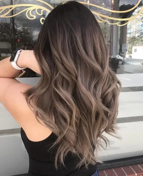Long wavy dark brown-to-ash ombre lob with soft S-shaped layers and tapered ends