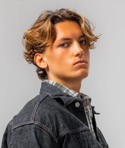 Long layered wavy hair with loose tousled curls and fringe