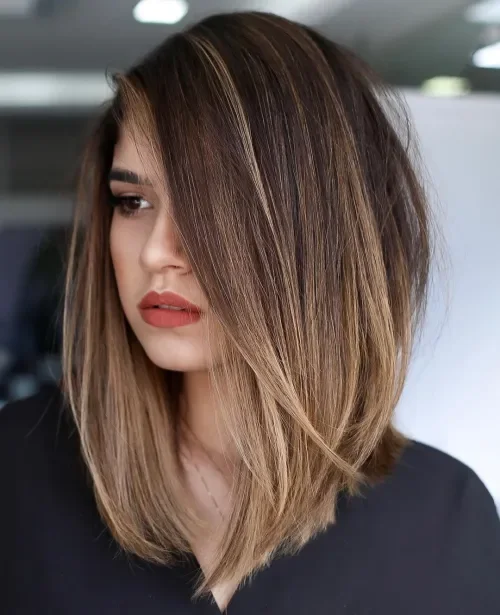 Clavicut lob with collarbone length layers and dark-root balayage ribbons in smooth finish.