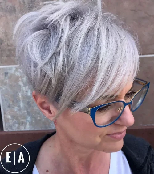 Icy silver-gray pixie with soft wispy bangs and longer layered top