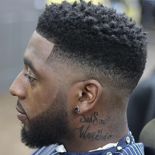 High fade with thick curly top and clean hairline