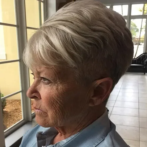 Short ash blonde pixie crop with longer, wavy side-swept top and close sides