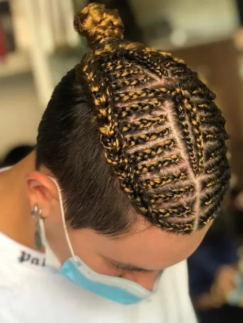 Honey-gold highlighted twisted braids gathered into a tight rounded updo