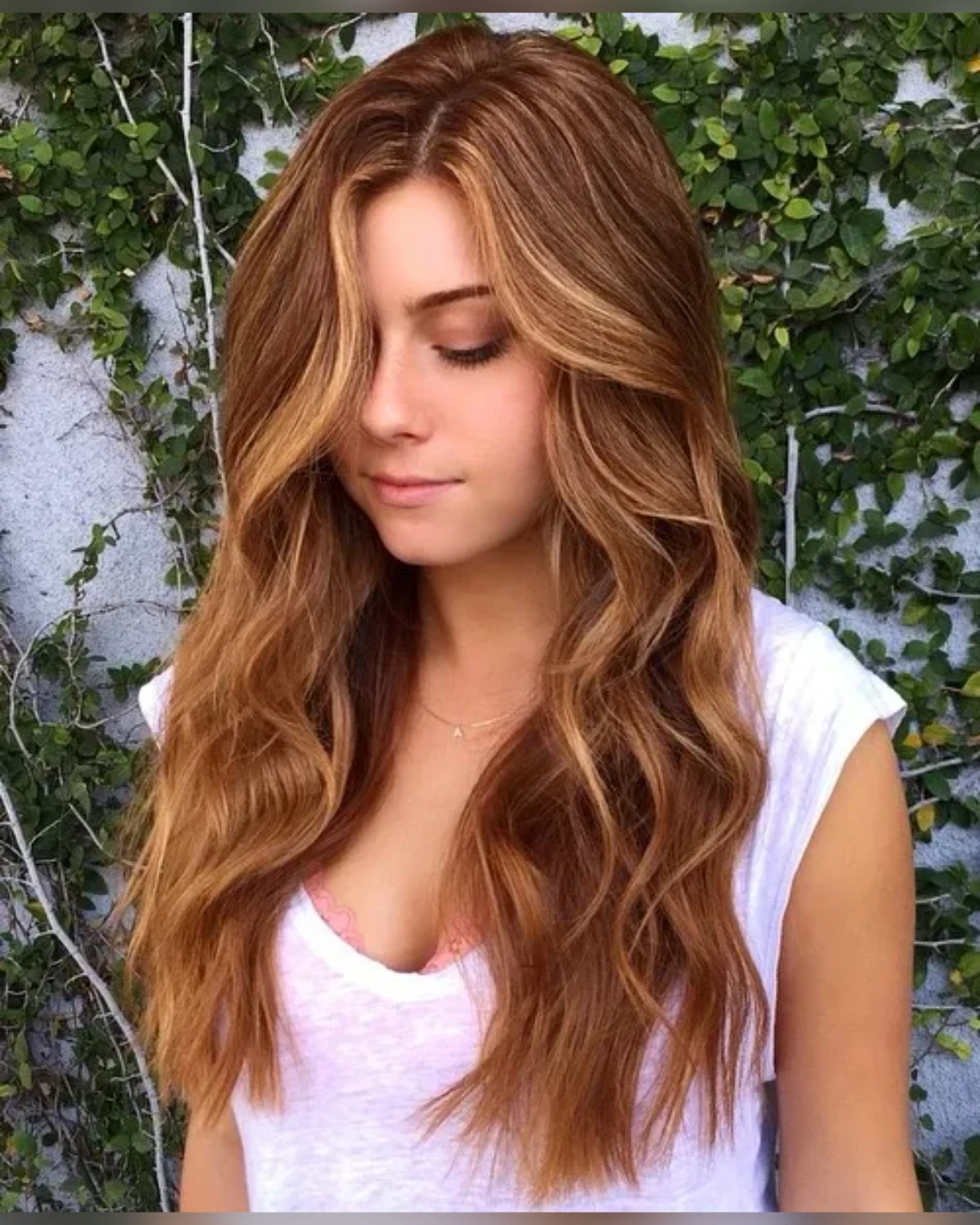 Warm brown lob with golden caramel highlights and soft loose waves.
