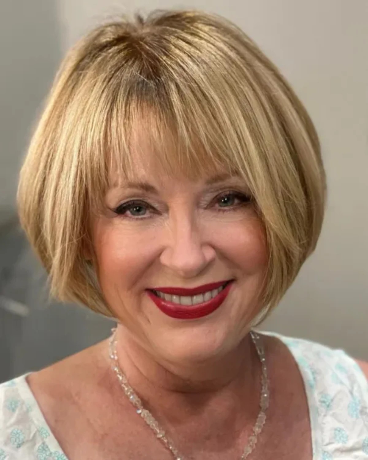 Classic blonde bob with straight fringe and subtle outward curl